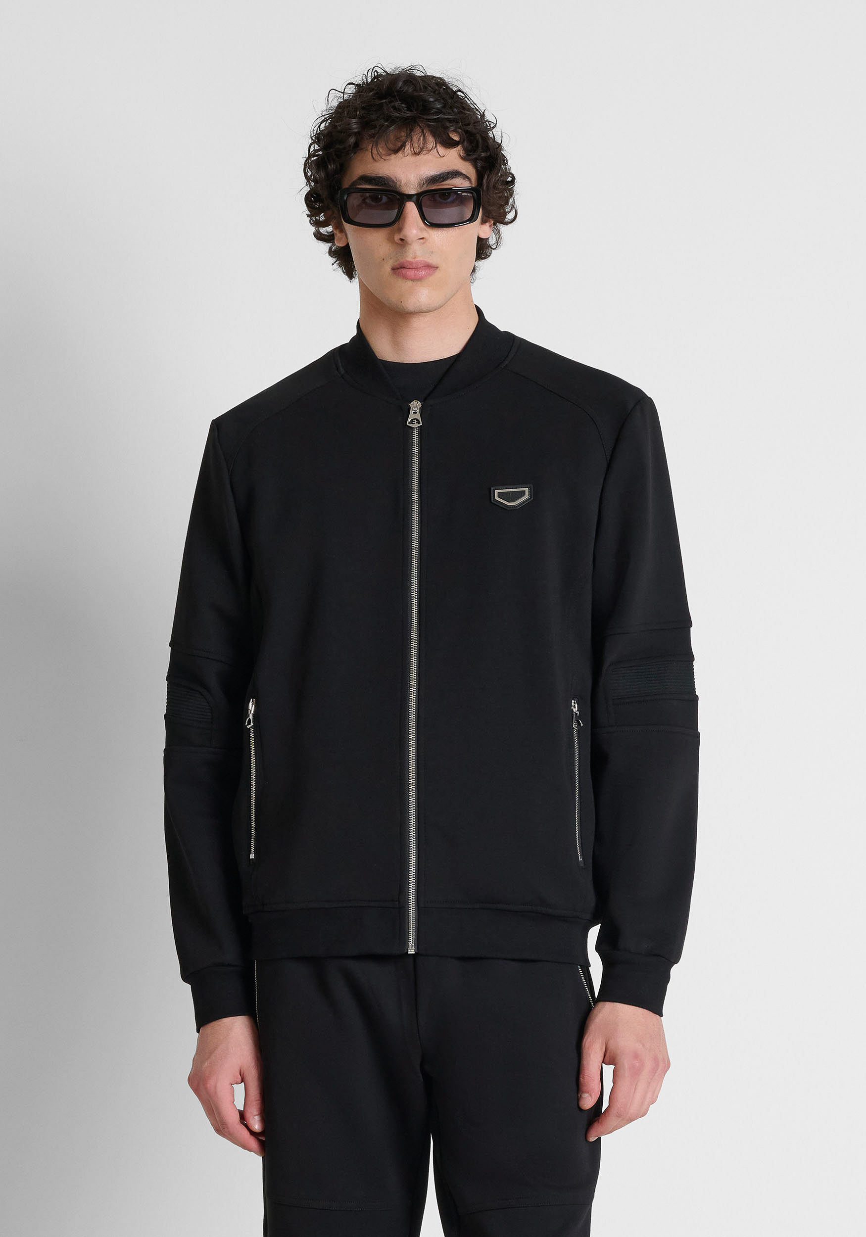 Black regular-fit zip-up fleece in interlock with metal plate on