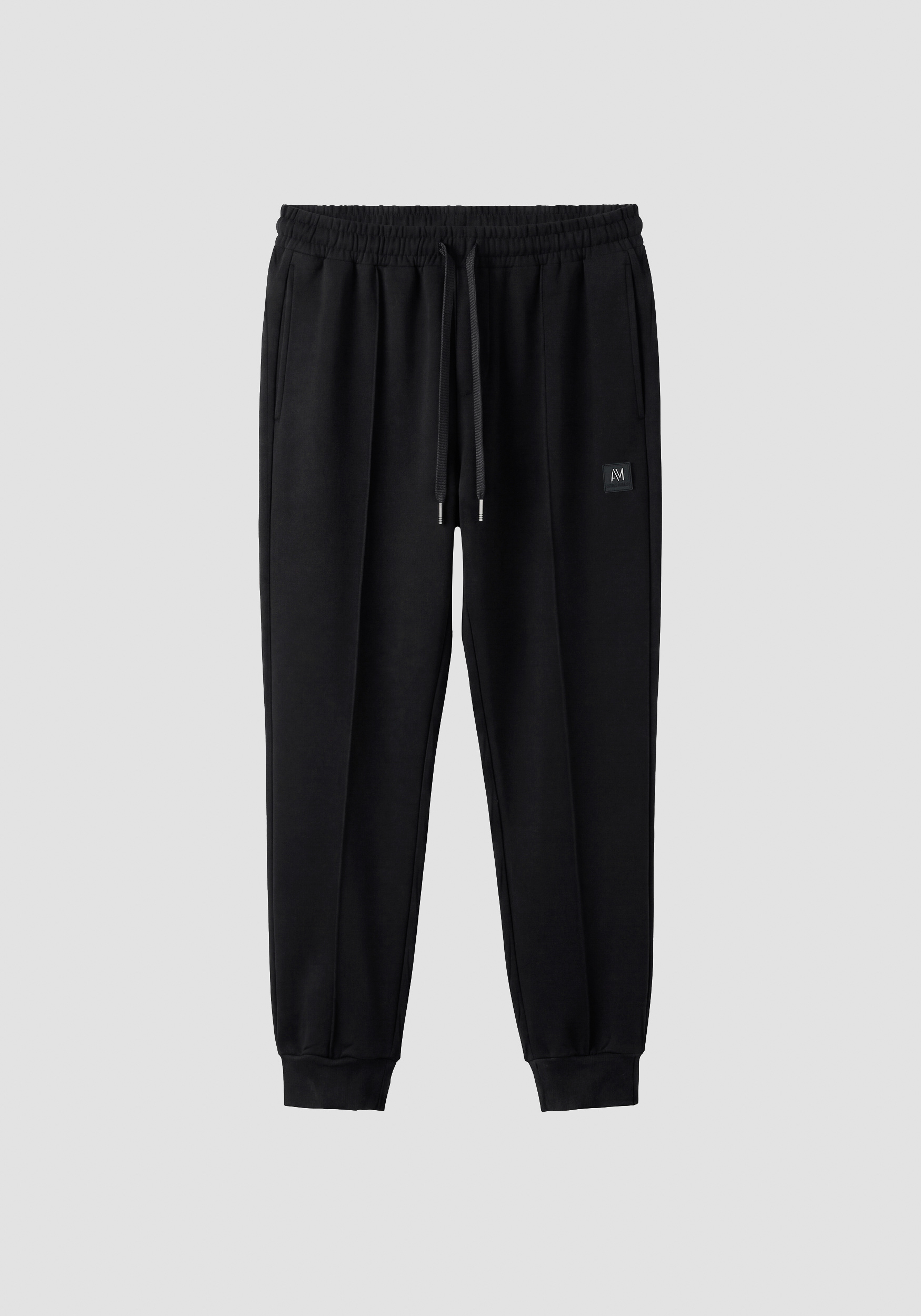 Black carrot-fit fleece trousers in cotton interlock with logo on